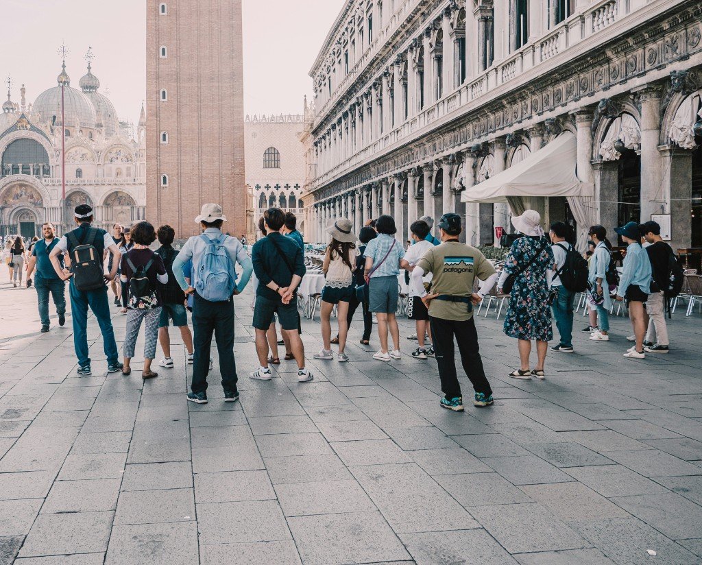 Grupo de turistas en una plaza frente a monumentos